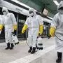 Workers wearing protective gear spray disinfectant as part of preventive measures against the spread of the COVID-19 coronavirus, at a subway station in Seoul on February 28, 2020. - K-pop megastars BTS on February 28 cancelled four concerts they were due to hold in Seoul in April, their agency said, as the coronavirus outbreak spreads in South Korea. The country has so far confirmed more than 2,000 cases of the novel coronavirus, by far the largest national total outside China, the origin of the disease. (Photo by - / YONHAP / AFP) / - South Korea OUT / REPUBLIC OF KOREA OUT  NO ARCHIVES  RESTRICTED TO SUBSCRIPTION USE