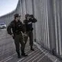 FILE - Police border guards patrol along a border wall near the town of Feres, along the Evros River which forms the frontier between Greece and Turkey on Sunday, Oct. 30, 2022. Greece prevented some 260,000 migrants from entering illegally in 2022 and arrested 1,500 traffickers, Greece's minister in charge of the security told ambassadors from other European Union countries plus Switzerland and the United Kingdom Saturday, Jan. 21, 2023, as he guided them to a still expanding border wall in the country's northeast. (AP Photo/Petros Giannakouris, File)