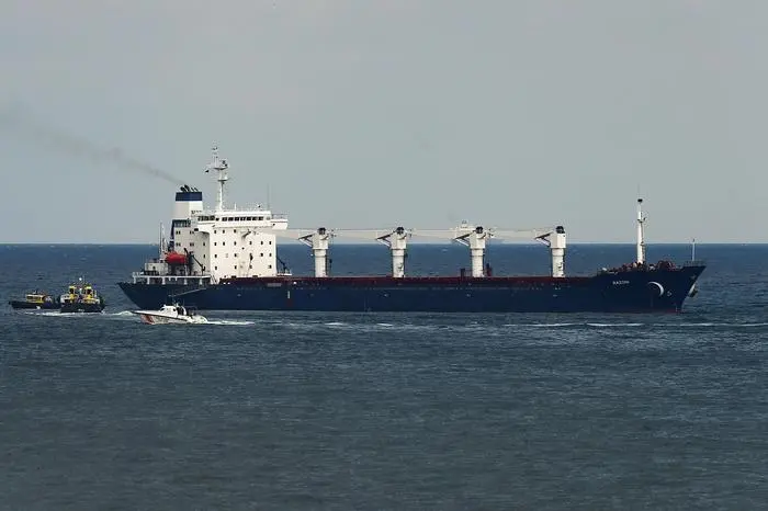 A boat with Russian, Ukrainian, Turkish and U.N. officials heads to the Sierra Leone-flagged cargo ship Razoni, to check if the grain shipment is in accordance with a crucial agreement signed last month by Moscow and Kyiv, at an inspection area in the Black Sea off the coast of Istanbul, Turkey, Wednesday, Aug. 3, 2022. The cargo ship Razoni, loaded up with 26,000 tons of corn, set sail from Ukraine's Odesa on Monday, enroute to final destination, Lebanon.(AP Photo/Emrah Gurel)