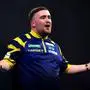 England's Luke Littler reacts during his match against England's Rob Cross on day sixteen of the World Darts Championship at the Alexandra Palace, in London, Monday, Dec. 29, 2025. (John Walton/PA via AP)