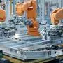 EV Battery Pack Automated Production Line Equipped with Orange Robot Arms. Modern Electric Car Smart Factory. Row of Advanced Robotic Arms inside Bright Plant Assemble Batteries for Automotive Industry