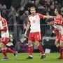 Bayern's Harry Kane, centre, celebrates with teammates after scoring his side's opening goal during the German Bundesliga soccer match between Bayern Munich and Stuttgart in Munich, Germany, Sunday, Dec.17, 2023. (AP Photo/Matthias Schrader)
