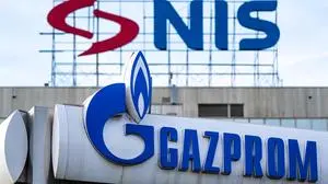 This photograph shows the logo of the Naftna Industrija Srbije - NIS (Petroleum Industry of Serbia) is displayed on the facade of the company's headquarters above the logo of  a Gazprom gas station in Belgrade on November 25, 2025, as Serbia's only oil refinery faces a complete shutdown within days after US' sanctions over its majority Russian ownership cut off crude supply. The president said the Pancevo refinery's operations had scaled back to "warm circulation" and were four days away from a "complete halt", industry sources told local media that oil production had ceased. Since October 2025, the Petroleum Industry of Serbia (NIS) has been hit with sanctions as part of Washington's crackdown on Russia's energy sector after the 2022 invasion of Ukraine. (Photo by Andrej ISAKOVIC / AFP)