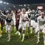 Poland players celebrate after defeating Wales in a penalty shoot out during their Euro 2024 soccer play-off match at Cardiff City Stadium, Wales, Tuesday, March 26, 2024. (AP Photo/Alastair Grant)