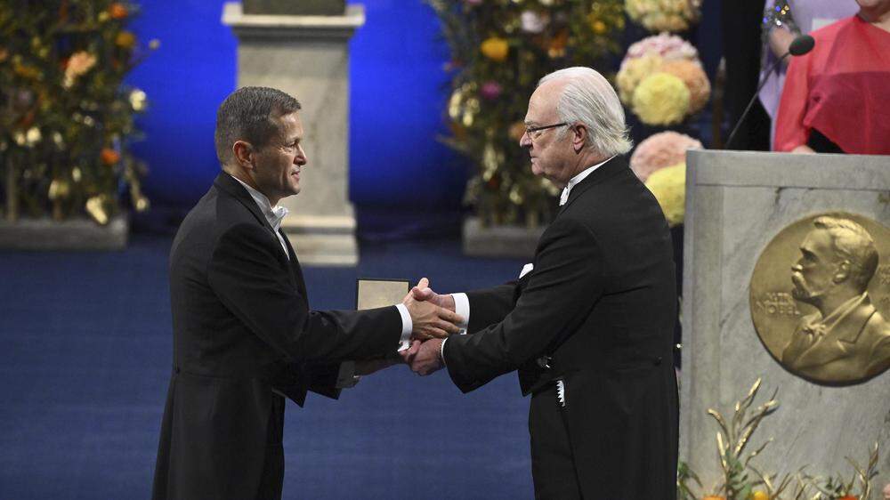 Ferenc Krausz, left, is awarded the 2023 Nobel Prize in Physics by Sweden's King Carl Gustaf during the Nobel Prize award ceremony at the Concert Hall in Stockholm, Sweden, Sunday Dec. 10, 2023. (Claudio Bresciani/TT via AP)