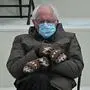 TOPSHOT - Former presidential candidate, Senator Bernie Sanders (D-Vermont) sits in the bleachers on Capitol Hill before Joe Biden is sworn in as the 46th US President on January 20, 2021, at the US Capitol in Washington, DC. (Photo by Brendan SMIALOWSKI / AFP)