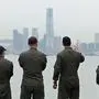 (FILES) This file photo taken on August 20, 2014 shows US Navy personnel on board the USS Makin Island looking towards the ICC building (C) during a port-of-call visit to Hong Kong. - China said on December 2, 2019 it had suspended rest and recuperation visits by US warships in Hong Kong in response to a US bill supporting pro-democracy protesters in the semi-autonomous city. (Photo by Anthony WALLACE / AFP)