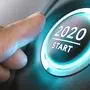 Finger about to press a car ignition button with the text 2020 start. Year two thousand and twenty concept.