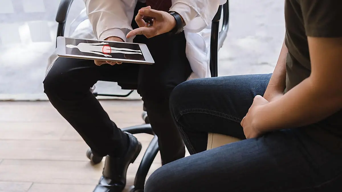 Male doctor and testicular cancer patient are discussing about testicular cancer test report. Testicular cancer and prostate cancer concept.