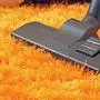 modern vacuum cleaner closeup on orange carpet