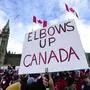 A participant holds an "Elbows Up Canada" sign during rally in response to U.S. President Donald Trump's threats to Canadian sovereignty, on Parliament Hill in Ottawa, on Sunday, March 9, 2025. (Justin Tang/The Canadian Press via AP)