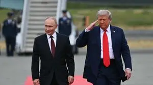 US President Donald Trump salutes as he walks with Russian President Vladimir Putin on the tarmac after they arrived at Joint Base Elmendorf-Richardson in Anchorage, Alaska, on August 15, 2025. Putin is in Alaska at the invitation of Trump in his first visit to a Western country since he ordered the 2022 invasion of Ukraine that has killed tens of thousands of people. (Photo by ANDREW CABALLERO-REYNOLDS / AFP)