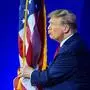 Former US president and 2024 presidential hopeful Donald Trump kisses the US flag as he arrives to speak during the annual Conservative Political Action Conference (CPAC) meeting on February 24, 2024, in National Harbor, Maryland. (Photo by Mandel NGAN / AFP)