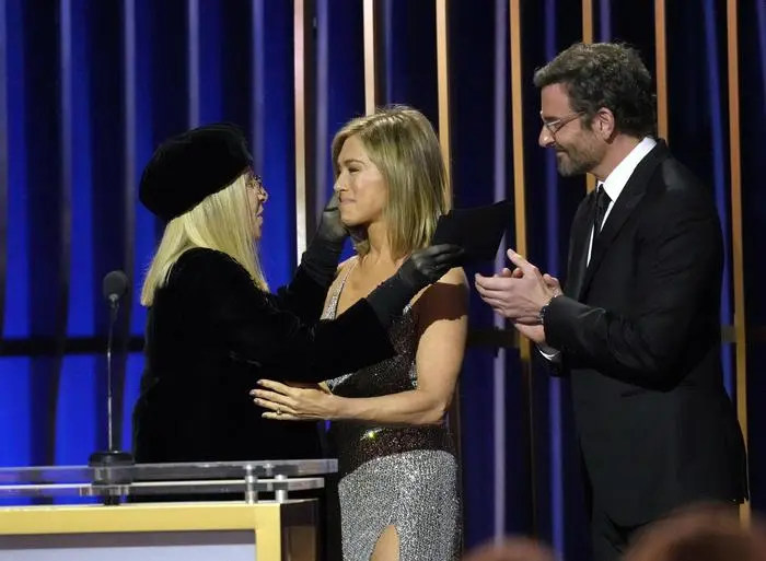 Barbara Streisand, from left, accepts the lifetime achievement award from Jennifer Aniston, center, and Bradley Cooper during the 30th annual Screen Actors Guild Awards on Saturday, Feb. 24, 2024, at the Shrine Auditorium in Los Angeles. (AP Photo/Chris Pizzello)