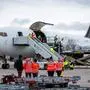 Humanitarian aid supplies from the German Red Cross (DRK) for the civilian population in Gaza are loaded into a transport plane at Leipzig/Halle Airport in Schkeuditz, eastern Germany on January 07, 2024. The first aid transports, around 33 tons of material are sent to the Gaza Strip, including around 1.000 family tents and 1.000 tarpaulins for emergency shelters. A second aid flight with around 26 tons is planned for Monday. (Photo by JENS SCHLUETER / AFP)