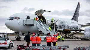 Humanitarian aid supplies from the German Red Cross (DRK) for the civilian population in Gaza are loaded into a transport plane at Leipzig/Halle Airport in Schkeuditz, eastern Germany on January 07, 2024. The first aid transports, around 33 tons of material are sent to the Gaza Strip, including around 1.000 family tents and 1.000 tarpaulins for emergency shelters. A second aid flight with around 26 tons is planned for Monday. (Photo by JENS SCHLUETER / AFP)