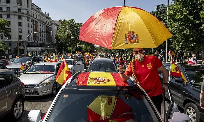 People wave Spanish flags during a drive-in protest organised by Spain's far-right Vox party against the Spanish government's handling of the nation's coronavirus outbreak in Madrid, Spain Saturday, May 23, 2020. (AP Photo/Manu Fernandez)