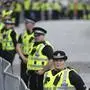 Police line the route prior to the arrival of the Queens cortege with the hearse containing her coffin on the Royal Mile in Edinburgh, Scotland, Sunday, Sept. 11, 2022. The coffin of the late Queen Elizabeth II is being transported Sunday on a journey from Balmoral to the Palace of Holyroodhouse in Edinburgh, where it will lie at rest before being moved to London later in the week. (AP Photo/Jon Super)