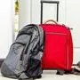 red travel bag , backpack and shoes by front door 