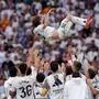 Real Madrid's Croatian midfielder #10 Luka Modric is tossed into the air by teammates at the end of the Spanish league football match between Real Madrid CF and Real Sociedad at Santiago Bernabeu Stadium in Madrid on May 24, 2025. (Photo by OSCAR DEL POZO / AFP)