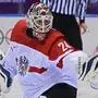 epa04085060 Goalie Mathias Lange of Austria blocks the puck against Slovenia in the second period during their Play-offs Qualifications match in the Ice Hockey tournament at the Sochi 2014 Olympic Games in Sochi, Russia, 18 February 2014.  EPA/LARRY W. SMITH