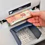 Noch schnell Bargeld abheben . Am Geldautomaten in der Bank. Bad Reichenhall Bayern Deutschland *** Still quickly withdraw cash At the ATM in the bank Bad Reichenhall Bavaria Germany Copyright: xRolfxPossx