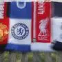 A selection of scarves of the English soccer Premier League teams who are reported to be part of a proposed European Super League, laid out and photographed, in London, Monday, April 19, 2021. The 12 European clubs planning to start a breakaway Super League have told the leaders of FIFA and UEFA that they have begun legal action aimed at fending off threats to block the competition. (AP Photo/Alastair Grant)