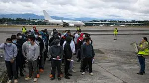 Guatemalan migrants deported from the United States stand in formation on the runway after arriving at the Guatemalan Air Force Base in Guatemala City on January 2, 2025, during the first deportee flight of the year. Guatemala closes 2024 with more than 61,000 deported from the US. (Photo by JOHAN ORDONEZ / AFP)