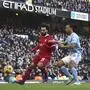 Liverpool's Mohamed Salah, left, challenges for the ball with Manchester City's Nathan Ake during the English Premier League soccer match between Manchester City and Liverpool at Etihad stadium in Manchester, England, Saturday, Nov. 25, 2023. (AP Photo/Rui Vieira)