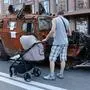  August 23, 2022, Kyiv, Ukraine: A man with a child in a stroller observes the destroyed Russian army equipment exhibited on Khreshchatyk in the center of Kyiv. Captured Russian military equipment is being temporarily displayed on Khreschaytk street in the heart of the Ukrainian capital. The area has become a popular attraction among residents curious to see Ukraine s spoils of war. Kyiv Ukraine - ZUMAs197 20220823_zaa_s197_101 Copyright: xAleksandrxGusevx