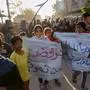 TOPSHOT - Children carry signs reading in Arabic: "We refuse to die" during a rally calling for an end to the war, in Beit Lahia, in the northern Gaza Strip, on March 25, 2025. Hundreds of Palestinians chanted anti-Hamas slogans at a protest in northern Gaza on March 25, calling for an end to the war with Israel, witnesses said. (Photo by AFP)