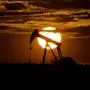 FILE - The sun sets behind an idle pump jack near Karnes City, USA, April 8, 2020.  Oil markets have been fluctuating over fears of lost supplies from Russia because of the war in Ukraine. But the alliance of OPEC members and allied oil-producing countries are likely to steer a steady course when they decide production levels at an online meeting Thursday. The OPEC+ alliance has been opening the taps only gradually to restore cuts made during the worst of the pandemic recession. (AP Photo/Eric Gay, File)