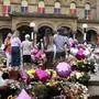 FILE - People look at the floral tribute at the Atkinson arts centre in Southport, England, Monday, Aug. 5, 2024 after three young girls were killed in a knife attack at a Taylor Swift-themed holiday club the week before. (AP Photo/Darren Staples, File)