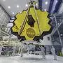 FILE - In this April 13, 2017 photo provided by NASA, technicians lift the mirror of the James Webb Space Telescope using a crane at the Goddard Space Flight Center in Greenbelt, Md. NASA announced Tuesday, Dec. 14, 2021, that next week’s launch of its new space telescope is delayed for at least two days because of a communication problem between the observatory and the rocket.  Liftoff of the James Webb Space Telescope is now targeted for no earlier than Dec. 24. (Laura Betz/NASA via AP, File)