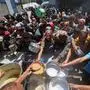 Palestinians queue for a hot meal at a charity kitchen run by the United Nation's World Food Programme (WFP) at the Nuseirat refugee camp in the central Gaza Strip on April 26, 2025. The UN food agency, one of the main providers of food assistance in the besieged Palestinian territory said on April 25 it had "delivered its last remaining food stocks to hot meals kitchens in the Gaza Strip", where Israel has blocked all aid for more than seven weeks, adding "these kitchens are expected to fully run out of food in the coming days". (Photo by Eyad BABA / AFP)