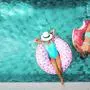 Two people (mom and child) relaxing on donut lilo in the pool at private villa. Summer holiday idyllic. High view from above.