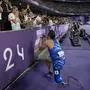 Italy's Alessandro Ossola asks her girlfriend to marry him after competing in the men's 100 m. T63 during the 2024 Paralympics, Sunday, Sept. 1, 2024, in Paris, France. (AP Photo/Christophe Ena)