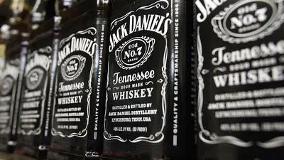 FILE - In this Dec. 5, 2011, file photo, bottles of Jack Daniel's Tennessee Whiskey line the shelves of a liquor outlet in Montpelier, Vt. Brown-Forman Corp. (BF.A) on Wednesday, June 6, 2018, reported fiscal fourth-quarter earnings of $110 million. (AP Photo/Toby Talbot, File)