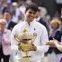 Carlos Alcaraz of Spain reacts after receiving his trophy from Kate, Princess of Wales after defeating Novak Djokovic of Serbia in the men's singles final at the Wimbledon tennis championships in London, Sunday, July 14, 2024. (AP Photo/Alberto Pezzali)