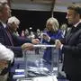 French President Emmanuel Macron, right, votes for the second round of the legislative elections in Le Touquet-Paris-Plage, northern France, Sunday July 7 2024. Voting has begun in mainland France on Sunday in pivotal runoff elections that could hand a historic victory to Marine Le Pen's far-right National Rally and its inward-looking, anti-immigrant vision — or produce a hung parliament and political deadlock. (Mohammed Badra, Pool via AP)