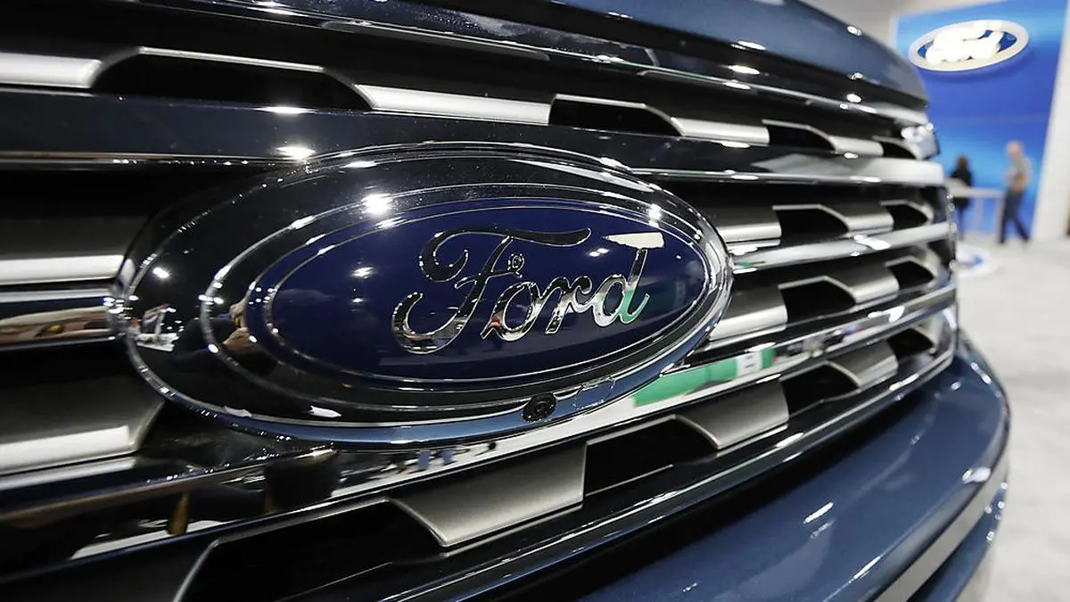 FILE - In this file photo dated Thursday, March 28, 2019, the Ford Motor company logo at the auto show in Denver, USA.  Carmaker Ford said Thursday June 27, 2019, it is shedding 12,000 jobs in Europe as it streamlines operations in the region to increase profitability. (AP Photo/David Zalubowski)