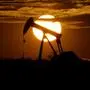 FILE - In this Wednesday, April 8, 2020 file photo, the sun sets behind an idle pump jack near Karnes City, USA. The OPEC oil cartel and allied countries are meeting to decide on production. The meeting is being closely watched because oil markets are tight and the price of crude is just off a three-year high as the global economy bounces back from the pandemic. (AP Photo/Eric Gay, File)