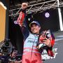 Ducati Spanish rider Marc Marquez celebrates on the podium winning the sprint race of the MotoGP Aragon Grand Prix at the Motorland circuit in Alcaniz, northeastern Spain, on August 31, 2024. (Photo by Pierre-Philippe MARCOU / AFP)