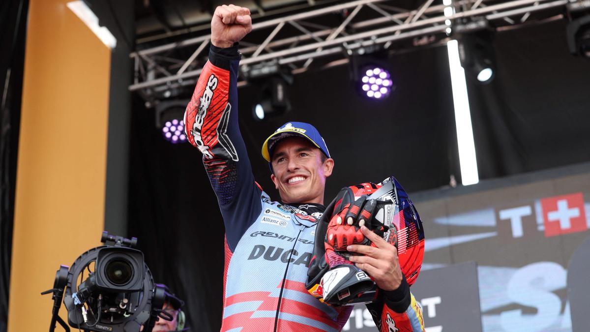 Ducati Spanish rider Marc Marquez celebrates on the podium winning the sprint race of the MotoGP Aragon Grand Prix at the Motorland circuit in Alcaniz, northeastern Spain, on August 31, 2024. (Photo by Pierre-Philippe MARCOU / AFP)