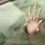 Couple holding hands having sex inside a car with a steamy window