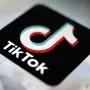 FILE - The TikTok app logo is displayed on a screen, Sept. 28, 2020, in Tokyo. A spokesperson for TikTok confirmed Tuesday, Jan. 23, 2024, that the social media platform is laying off dozens of workers in its advertising and sales unit, becoming the latest tech company to trim roles in the new year. (AP Photo/Kiichiro Sato, File)