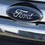 (FILES) In this file photo taken on December 31, 2014 a Ford logo is seen on the hood of a car at an automotive dealership in Landover Hills, Maryland, - Ford was forced to temporarily close an auto manufacturing plant in Chicago after two workers tested positive for coronavirus, the company told AFP on May 20, 2020. The incident on Tuesday highlights the difficulties facing US automakers, which restarted up production on Monday after shutting down in the wake of the coronavirus pandemic. (Photo by Saul LOEB / AFP)