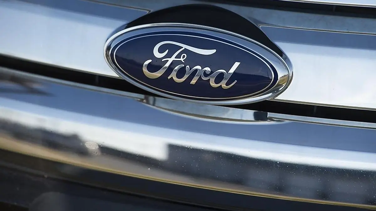 (FILES) In this file photo taken on December 31, 2014 a Ford logo is seen on the hood of a car at an automotive dealership in Landover Hills, Maryland, - Ford was forced to temporarily close an auto manufacturing plant in Chicago after two workers tested positive for coronavirus, the company told AFP on May 20, 2020. The incident on Tuesday highlights the difficulties facing US automakers, which restarted up production on Monday after shutting down in the wake of the coronavirus pandemic. (Photo by Saul LOEB / AFP)