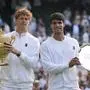 Jannik Sinner of Italy, ,left, and Carlos Alcaraz of Spain pose with the trophies after the men's singles final match at the Wimbledon Tennis Championships in London, Sunday, July 13, 2025.(AP Photo/Kirsty Wigglesworth)