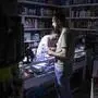 Power Blackouts In The Capital City While Iran Is On The Verge Of The Fifth Wave Of COVID-19 Outbreak An Iranian shopkeeper works as he and his customer stand at a supermarket while the electricity of his shop has been cut off due to energy savings by the Iranian Government, in downtown Tehran on July 5, 2021. Tehran Tehran Iran nikoubazl-powerbla210705_npCze PUBLICATIONxNOTxINxFRA Copyright: xMortezaxNikoubazlx 